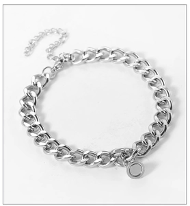 Detail of silver stainless steel curb chain bracelet with adjustable link and round charm