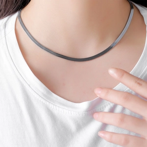 Flat silver snake chain necklace for men in stainless steel shown on male neck