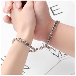 Close-up of magnetic coupling on silver Cuban link bracelets for couples in stainless steel