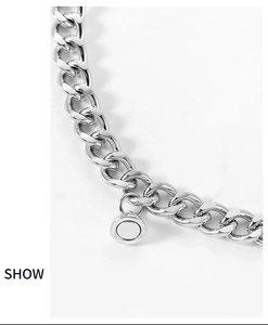 Detailed close-up of the polished silver Cuban link chain and magnetic heart charm