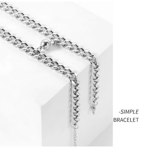 Detailed close-up of silver stainless steel magnetic couple bracelets on a white display block