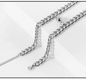 Close-up of silver stainless steel curb chain with spherical magnetic clasp and lobster hook