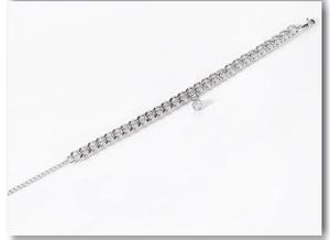 Detail of silver stainless steel Cuban link bracelet with magnetic heart closure clasp