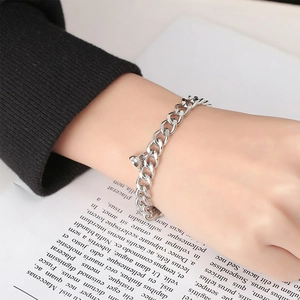 Polished silver stainless steel Cuban chain bracelet with a heart pendant for couples