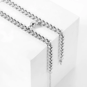 Magnetic stainless steel curb chain couple bracelets on minimalist geometric stands