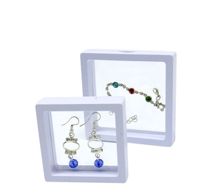 Macro detail of white 3D floating jewelry display boxes with transparent PE film and gemstones