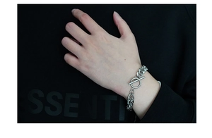Close-up of thick titanium steel Cuban link chain bracelet with a metal T-bar toggle clasp