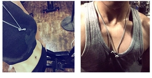 Silver dumbbell pendant necklace shown on fitness models in a gym setting