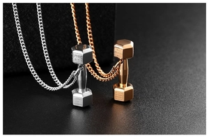 Macro shot of silver and rose gold dumbbell necklaces with engraved scripture details