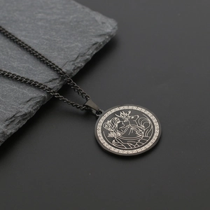 Detail of matte black Artemis goddess pendant with Greek key border and deer engraving