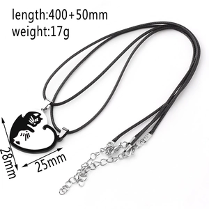 Detail view of heart-shaped cat pendant with black and white kitten mosaic design