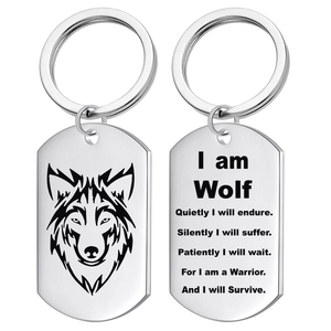 Detail view of double-sided stainless steel dog tag keychains with wolf head and motto