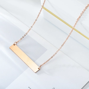 Elegant rose gold vertical bar necklace on marble background with a minimalist sleek design