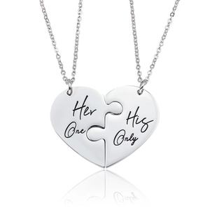 Close-up of heart puzzle couple necklaces with Her One and His Only engravings