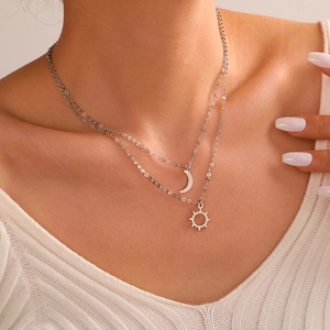 Double-layer stainless steel sun and moon pendant necklace on a female model