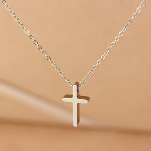 Minimalist silver-tone stainless steel necklace with a polished mini cross pendant for women