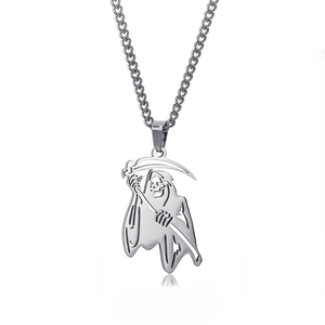 Macro shot of stainless steel Grim Reaper skull pendant with scythe in punk style