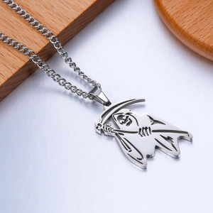 Macro shot of polished stainless steel reaper skull pendant with detailed hollow engraving