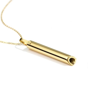 Detail view of gold stainless steel breathing necklace with a polished cylindrical pendant
