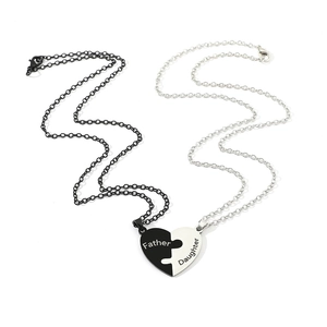 Detailed close-up of heart puzzle necklace set for father and daughter in stainless steel