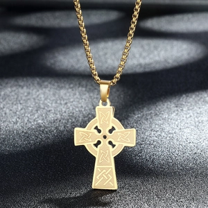 Golden Celtic cross necklace pendant with intricate knotwork on black fabric background