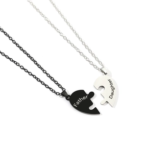 Detail of interlocking stainless steel Father and Daughter heart puzzle pendant necklace