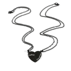 Close-up of black heart puzzle pendant set with engraved Father and Daughter text