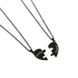 Detail of black stainless steel puzzle heart necklace with Brother and Sister engraving