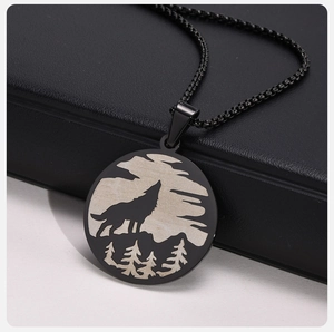 Close-up of a black stainless steel Viking wolf forest pendant with a beaded chain