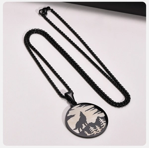 Detailed macro view of Viking wolf and forest silhouette pendant in black stainless steel