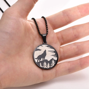 Vintage stainless steel Viking wolf forest pendant necklace held in hand for men