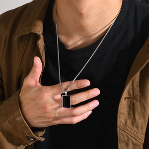 Men's rectangular black enamel pendant necklace with silver stainless steel chain on model