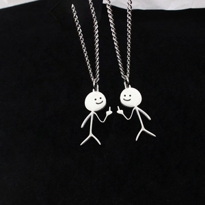 Funny stickman couple necklaces in polished stainless steel on black background
