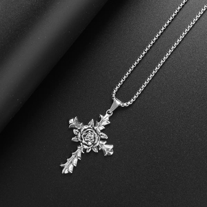 Macro detail of gothic silver rose cross pendant with intricate vintage carvings