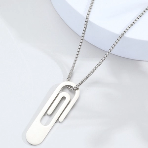 Macro shot of silver paperclip pendant with stainless steel box chain necklace