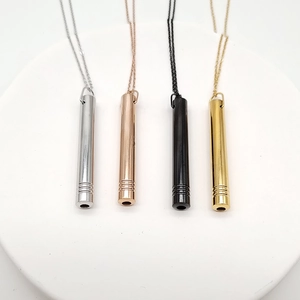 Detail of four cylinder meditation breathing necklaces in silver, gold, rose gold and black