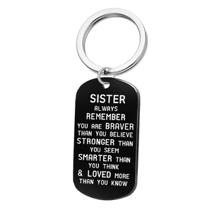 Detail of black rectangular dog tag keychain with white laser-engraved inspirational quote
