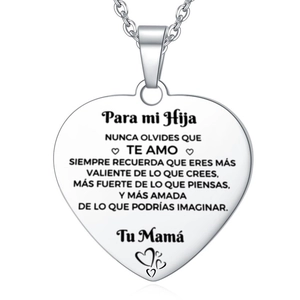 Close-up of heart pendant necklace with engraved Spanish message for son from mother