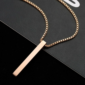 Macro shot of rose gold rectangular bar pendant with sleek box chain on black background