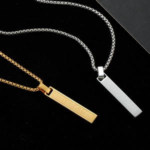 Detail of Roman numeral engraved bar pendants in silver and gold with box chains