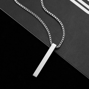 Macro shot of minimalist silver square pillar pendant with venetian box chain