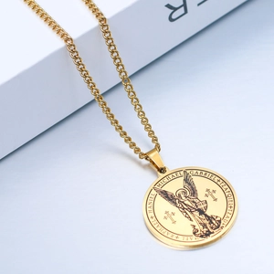 Macro detail of Archangel Michael gold medallion pendant showing intricate relief engraving