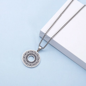 Macro shot of Viking rune pendant with Celtic knot pattern and stainless steel chain link