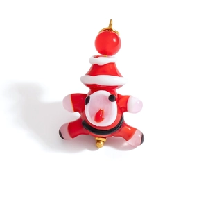 Detailed macro shot of a handmade lampwork glass Santa charm with gold hardware for DIY crafts