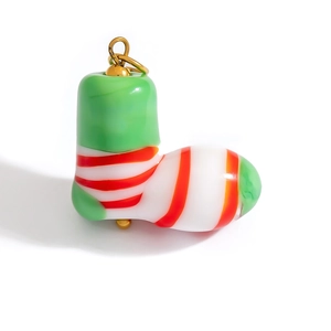 Detail view of a striped Christmas stocking pendant with vibrant green and red resin colors