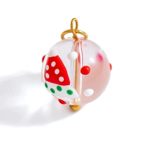Handmade glass Christmas bead with festive polka dots and santa hat pattern for DIY crafts
