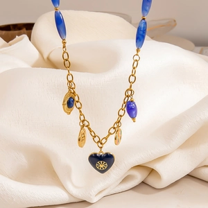 Bohemian gold stainless steel necklace with blue resin heart and embossed sun pendants