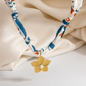 Elegant silk scarf necklace with golden flower pendant and pearl accent in center