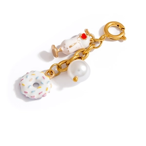 Stainless steel keychain with gold chain, white donut, pearl, and cocktail cup charms