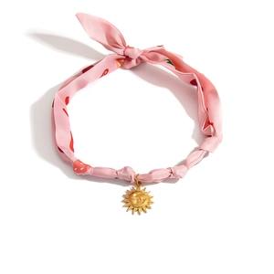 Pink strawberry silk choker necklace with gold sun and moon pendant on white background
